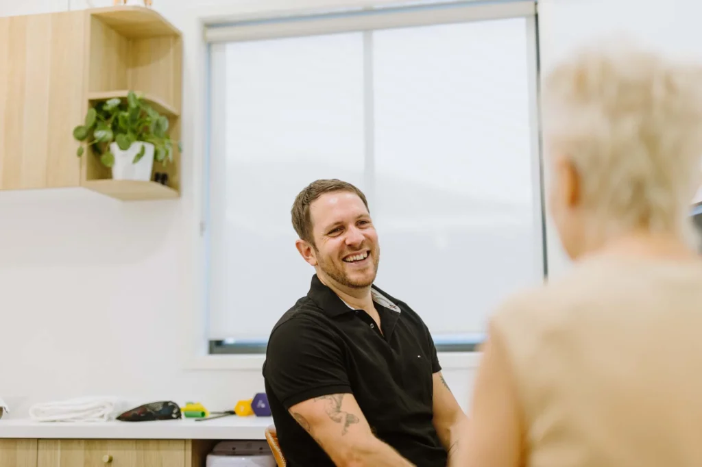 north coast head neck and jaw centre ballina osteopath Leon Erdrich talking to a northern rivers patient in their Ballina clinic